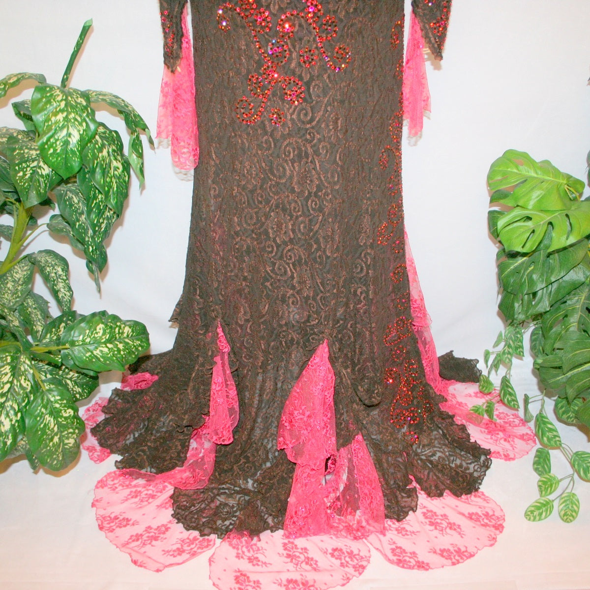 back bottom view of Brown lace tango dress, paso dress, fabulous bolero dress or rumba dress created in luxurious chocolate brown stretch lace with accent flounces of a deep pink glitter lace, embellished with Swarovski rhinestone detail work in Indian pink, mocha, & fuchsia.