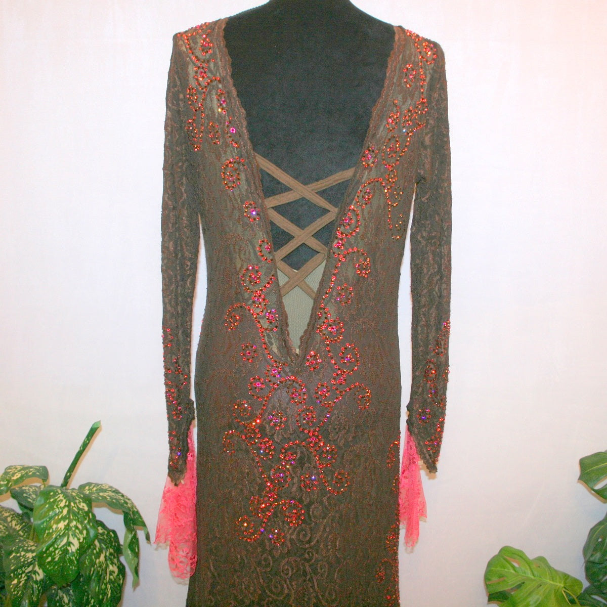 back tp view of Brown lace tango dress, paso dress, fabulous bolero dress or rumba dress created in luxurious chocolate brown stretch lace with accent flounces of a deep pink glitter lace, embellished with Swarovski rhinestone detail work in Indian pink, mocha, & fuchsia.